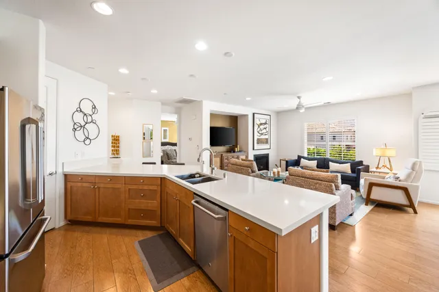 a large white kitchen with a stove and a refrigerator