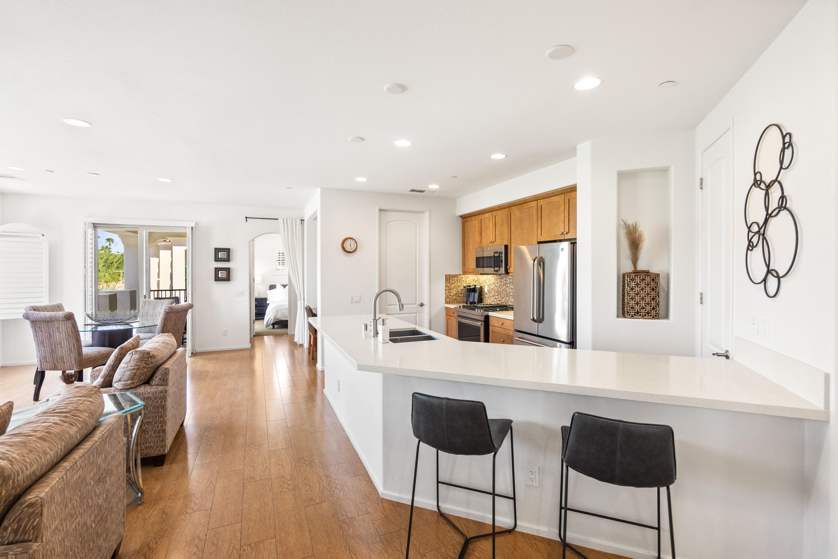 374 Terra Vita Palm Springs, CA 92262 - Photo 13 of 34 a large living room with stainless steel appliances furniture a large window and a kitchen view
