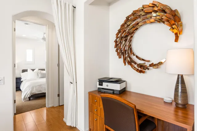 a bedroom with a bed and a mirror