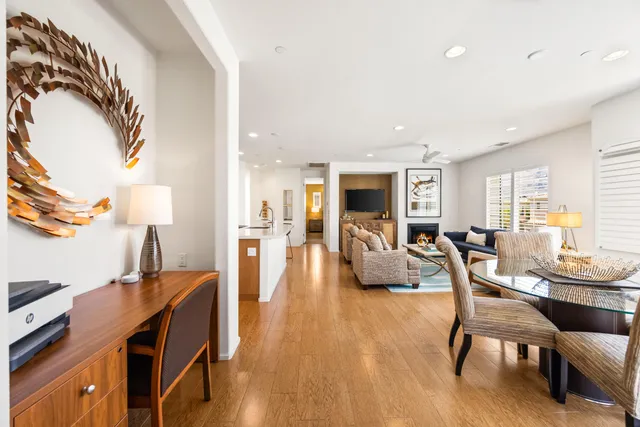 a dining room with furniture and wooden floor