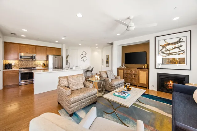a living room with fireplace furniture and a flat screen tv