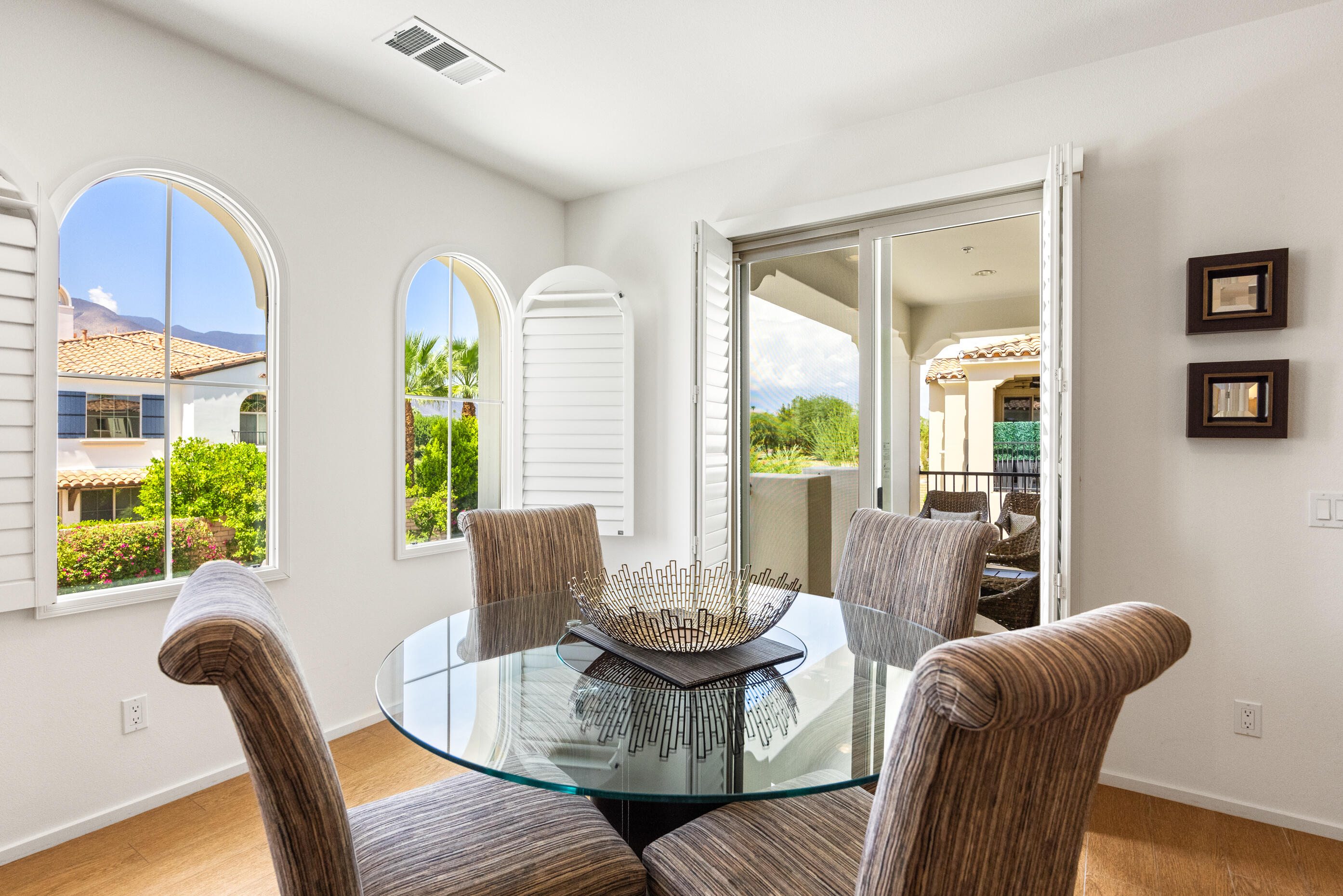 374 Terra Vita Palm Springs, CA 92262 - Photo 8 of 34 a dining room with furniture a large window and wooden floor