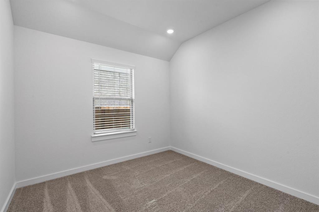 212 Brandywine Road Hutto, TX 78634 - Photo 16 of 35 Bedroom 3 featuring lofted ceiling, light carpet, and recessed lighting