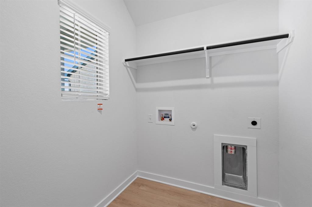 212 Brandywine Road Hutto, TX 78634 - Photo 19 of 35 Laundry Room with Washer & Dryer to be installed with the lease. Featuring light wood-style flooring.