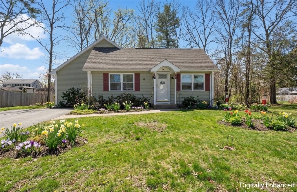 a front view of house with yard and green space