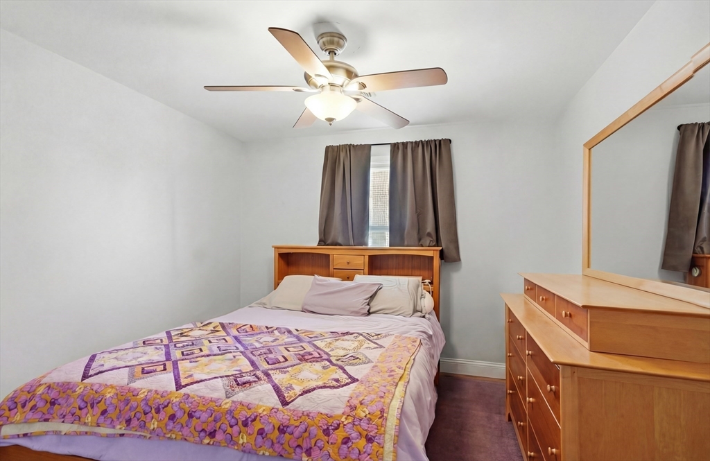 24 Holly Street Billerica, MA 01821 - Photo 16 of 33 a bedroom with a bed and a chandelier