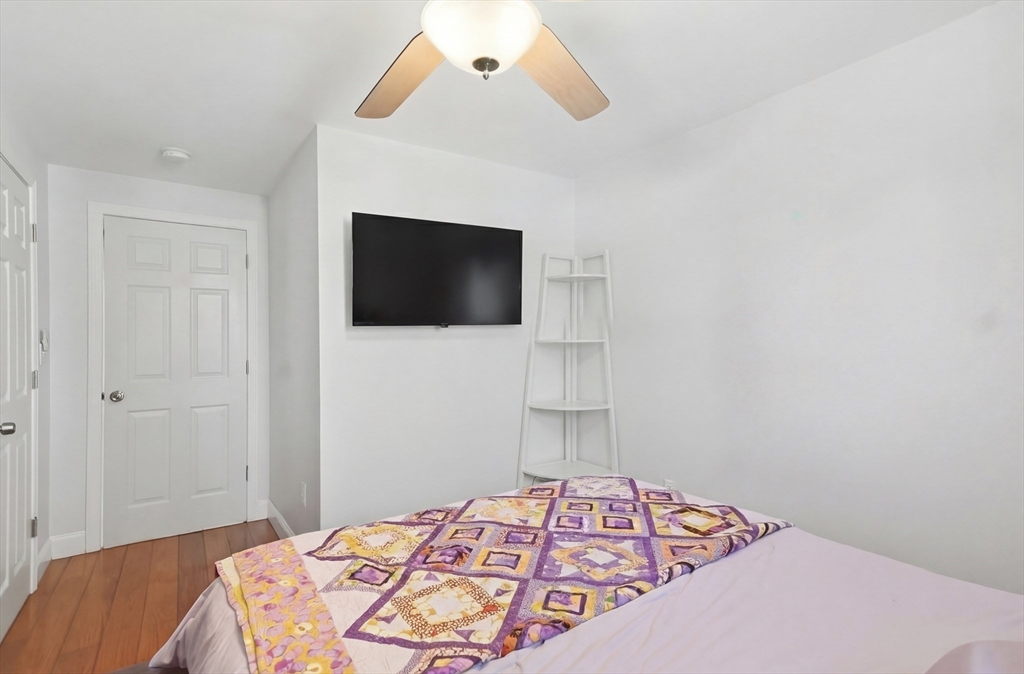 24 Holly Street Billerica, MA 01821 - Photo 17 of 33 a bedroom with a bed and a flat screen tv