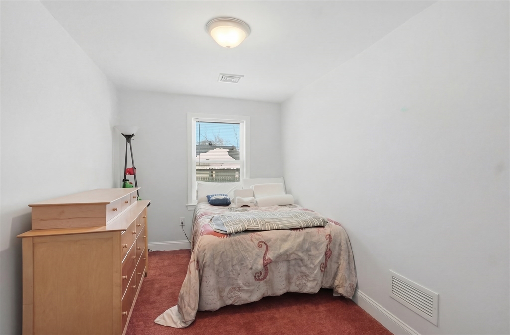 24 Holly Street Billerica, MA 01821 - Photo 18 of 33 a bedroom with a bed and a cabinets