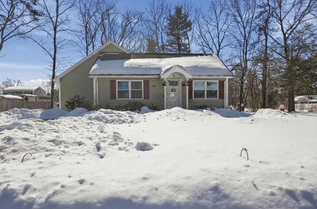24 Holly Street Billerica, MA 01821 - Photo 2 of 33 a view of a white house with a yard covered in snow