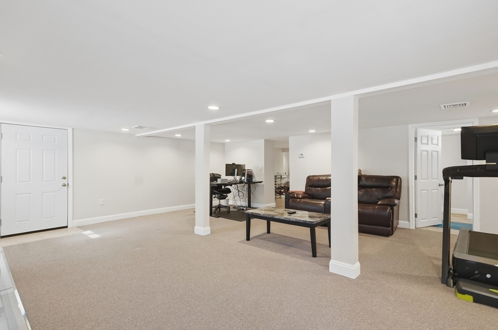 24 Holly Street Billerica, MA 01821 - Photo 21 of 33 a view of a livingroom with furniture and a flat screen tv