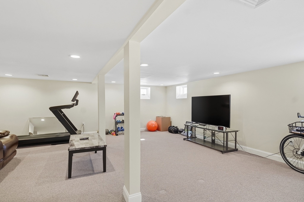 24 Holly Street Billerica, MA 01821 - Photo 22 of 33 a living room with furniture and a flat screen tv