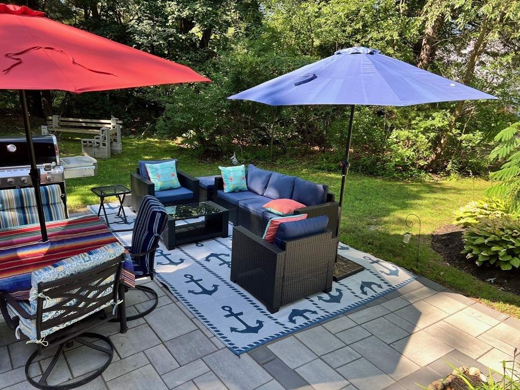 24 Holly Street Billerica, MA 01821 - Photo 30 of 33 a view of a patio with chairs and a table under an umbrella