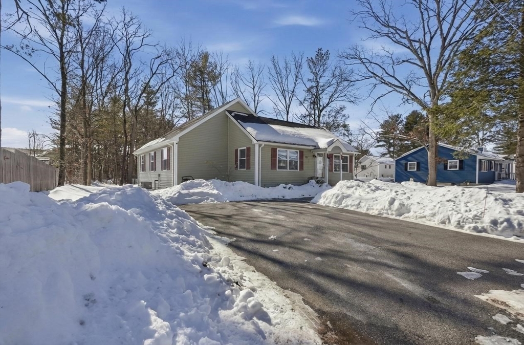 24 Holly Street Billerica, MA 01821 - Photo 3 of 33 a front view of a house with a yard covered in snow