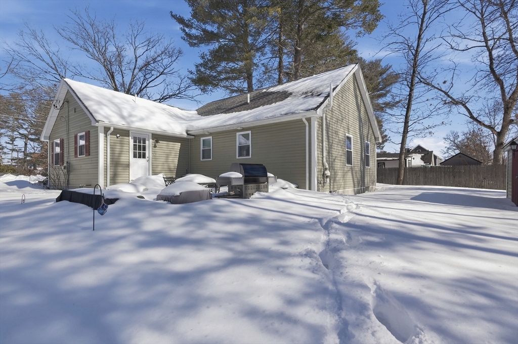 24 Holly Street Billerica, MA 01821 - Photo 32 of 33 a view of a house with a snow in the yard