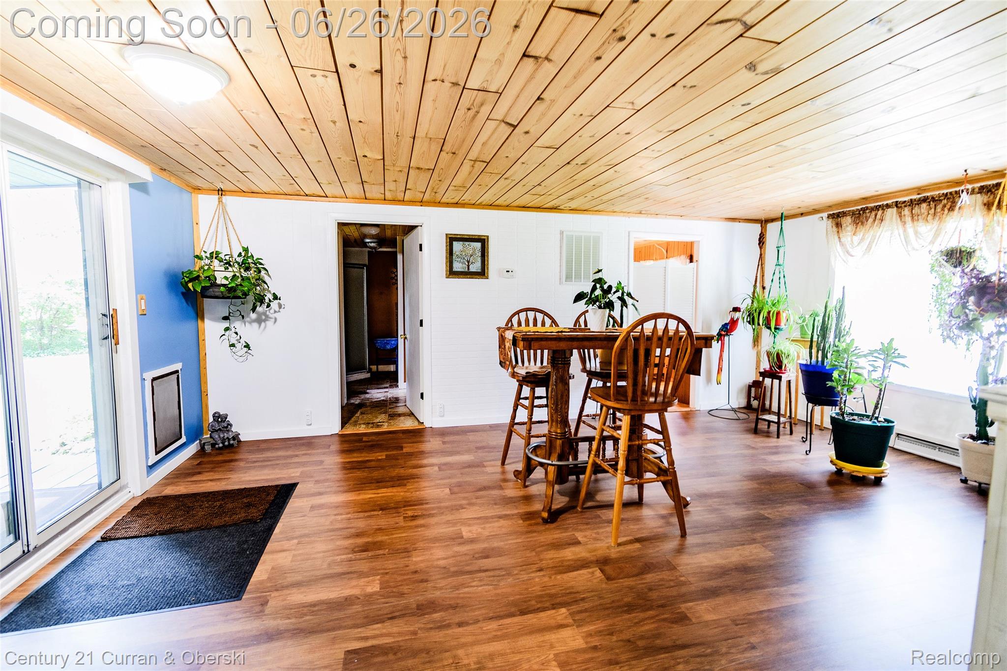 3270 Woods Road Harrison, MI 48625 - Photo 17 of 42 Spacious room featuring wood-finish flooring, a wood plank ceiling, and a large sliding glass door