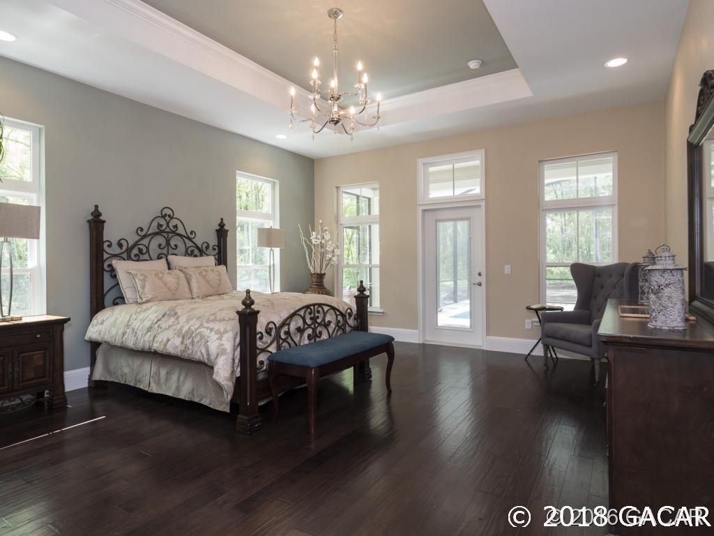 16889 Northwest 2nd Road Newberry, FL 32669 - Photo 9 of 24 Owners suite with wood floors