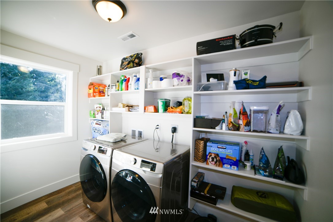 202 St Helens Way Winlock, WA 98596 - Photo 12 of 25 a utility room with lots of clutter and refrigerator