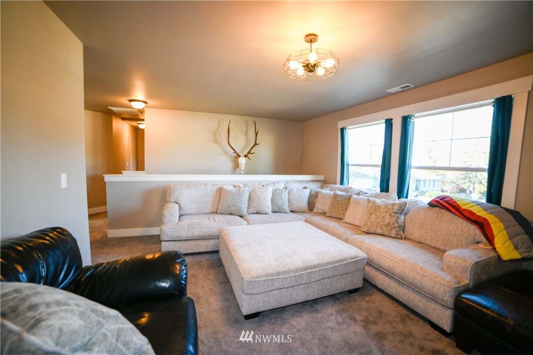 202 St Helens Way Winlock, WA 98596 - Photo 14 of 25 a living room with furniture and a large window