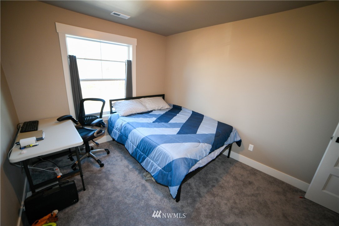 202 St Helens Way Winlock, WA 98596 - Photo 19 of 25 a bedroom with a bed and a window