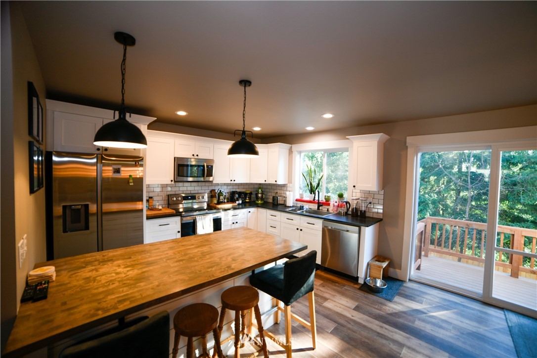 202 St Helens Way Winlock, WA 98596 - Photo 6 of 25 a kitchen with stainless steel appliances granite countertop a stove refrigerator and wooden floor