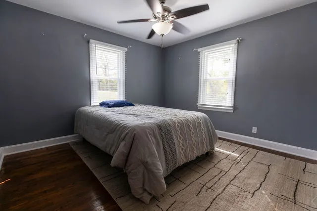 a bed sitting in a bedroom next to a window