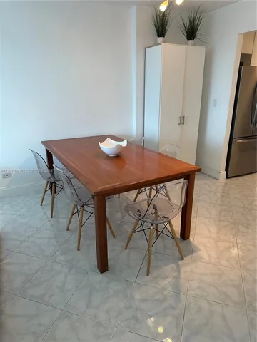 a view of a room with furniture and wooden floor