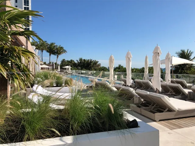 a view of swimming pool outdoor seating and city view
