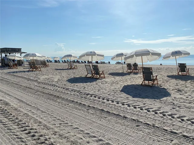 a large room with a large window and cars parked