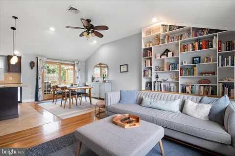 a living room with furniture and a book shelf