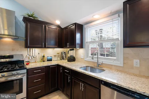 a kitchen with a sink stove and microwave