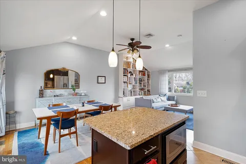 a room with a table chairs and wooden floor