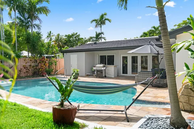 a view of a house with backyard porch and sitting area
