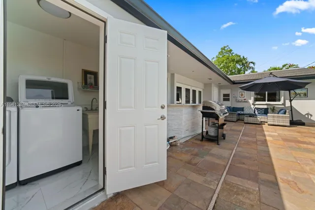 a view of a patio with furniture and a barbeque