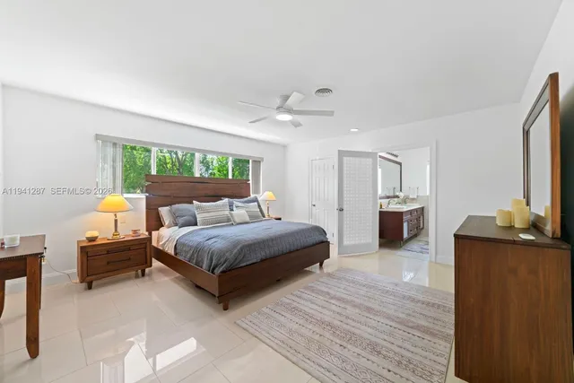 a spacious bedroom with a bed window and a table