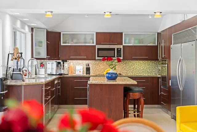 a kitchen with granite countertop a sink appliances and cabinets