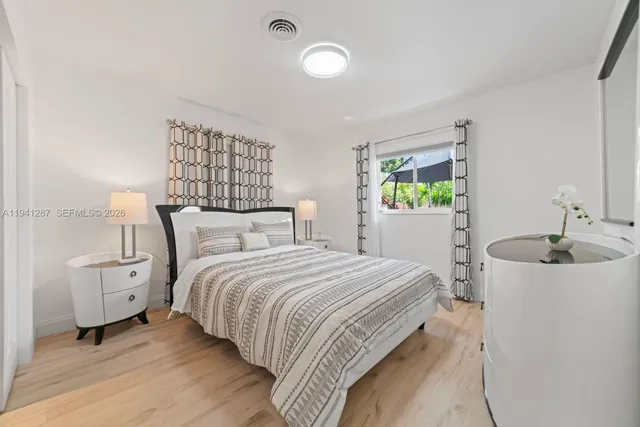 a bedroom with bed and window