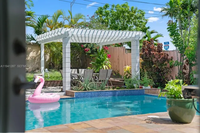 a view of a patio with table and chairs potted plants