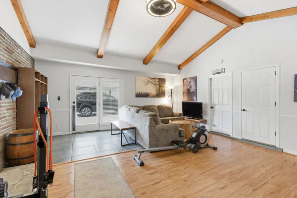 a view of a livingroom with workspace and a window