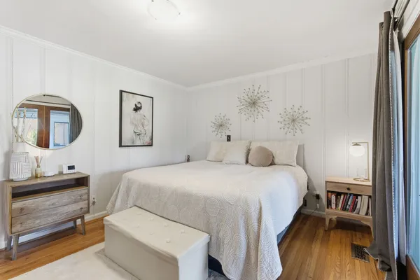 a bedroom with a bed and a dresser in it