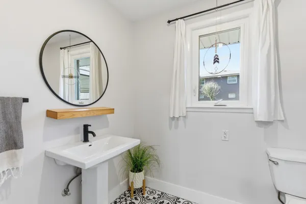 a bathroom with a sink a mirror and a toilet
