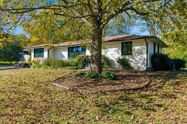 an aerial view of a house with yard and outdoor seating