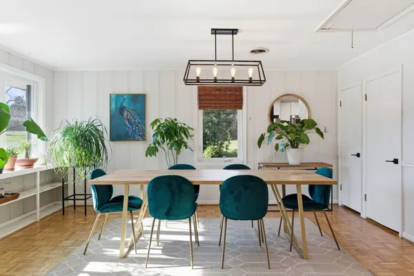a view of a dining room with furniture and chandelier