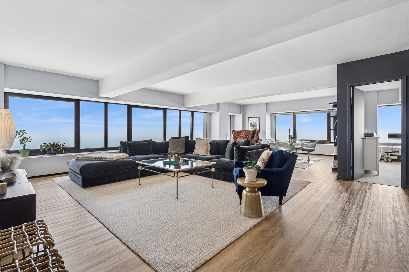 175 East Delaware Place, Unit 8504 Chicago, IL 60611 - Photo 9 of 22 a living room with furniture potted plant and a large window