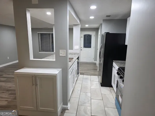 a kitchen with a refrigerator and a sink