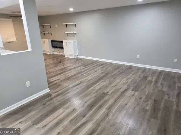 a view of kitchen with microwave and cabinets