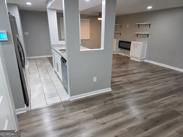 an entryway with wooden floor and livingroom view
