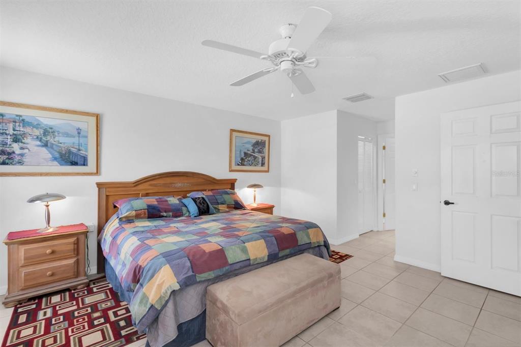 9052 Arundle Place New Port Richey, FL 34655 - Photo 15 of 57 a bedroom with two beds and painting on the wall