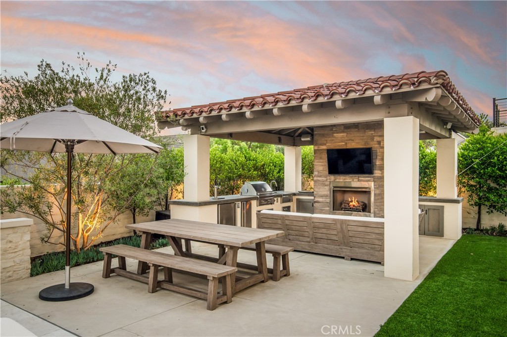 28750 Martingale Drive San Juan Capistrano, CA 92675 - Photo 3 of 45 a view of a patio with couches table and chairs under an umbrella with a small yard