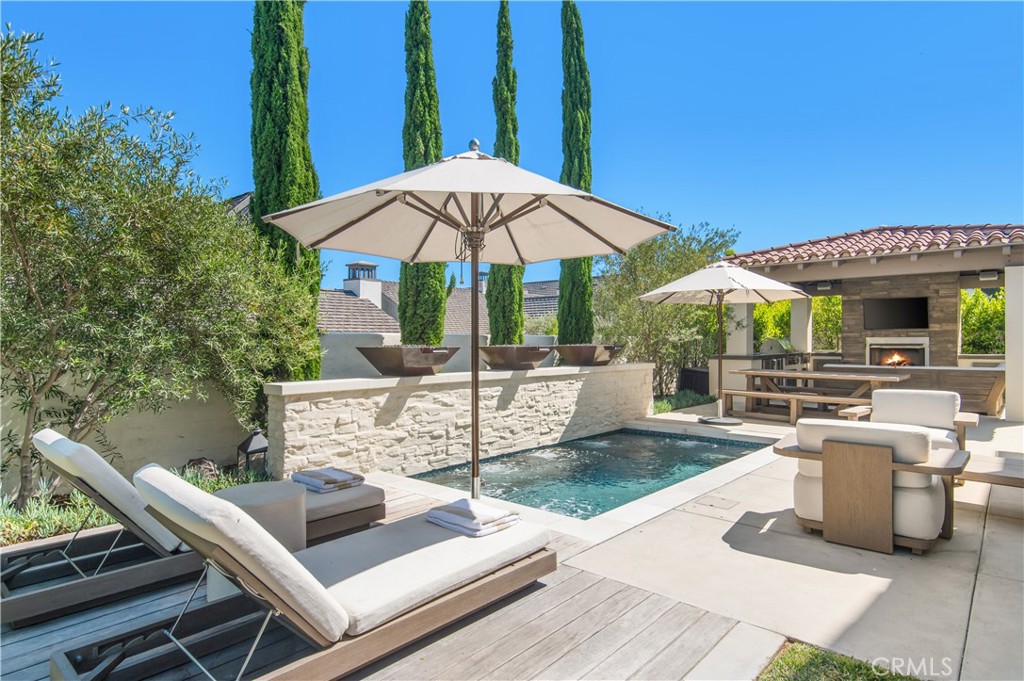 28750 Martingale Drive San Juan Capistrano, CA 92675 - Photo 36 of 45 a view of a patio with table and chairs under an umbrella