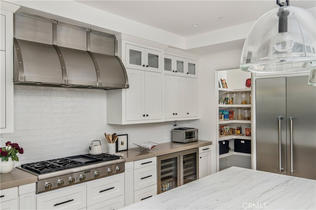 28750 Martingale Drive San Juan Capistrano, CA 92675 - Photo 9 of 45 a kitchen with stainless steel appliances a stove and cabinets